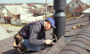 a-professional-master-roofer-with-hammer-repairs-2022-04-25-12-52-41-utc-min